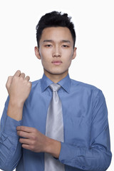 Businessman Buttoning His Sleeve