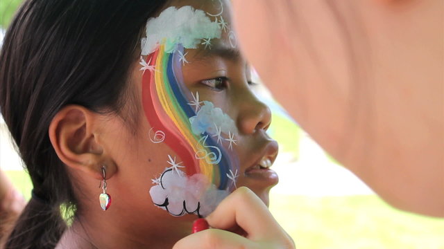 Girl Gets Rainbow Face Painting