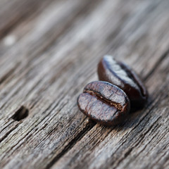 Closeup of coffee beans on grunge wooden background