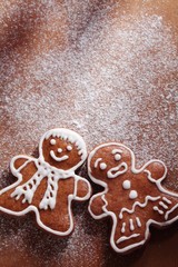 Christmas gingerbread men on sugar background with copy space