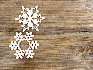 Snowflakes made of wood on wooden background