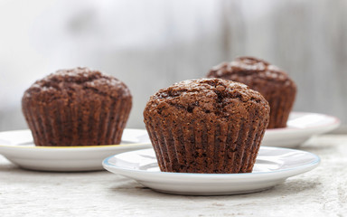Chocolate muffin on white plate