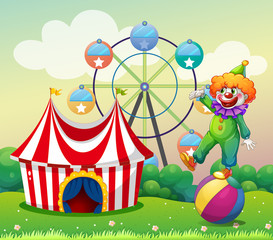 A clown standing above the ball at the carnival