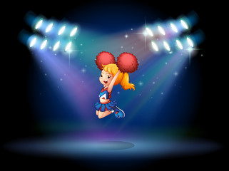 Obraz premium A cheerleader jumping in the middle of the stage