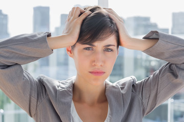 Stressed businesswoman looking at camera