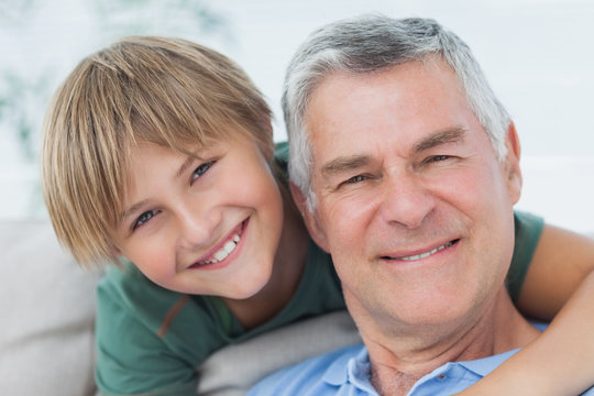 Portrait of grandson hugging grandfather