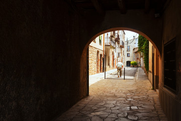 Fototapeta na wymiar Old street with archway in the European town