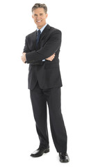 Portrait Of Confident Businessman Standing Arms Crossed