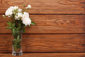 beautiful frame of the bouquet of white roses on a  wooden