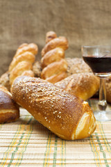 Still life assortment of bread with a glass of red wine.