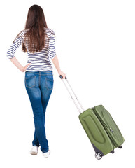 Back view of stylishly dressed brunette woman  with  suitcase lo