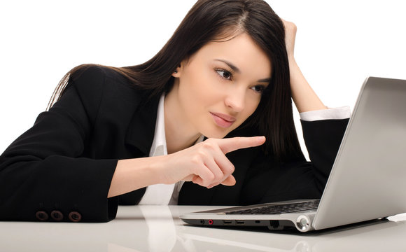 Beautiful brunette businesswoman working on a laptop