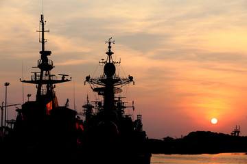 Fototapeta na wymiar battleship with sunset behind