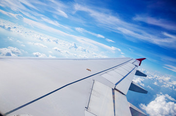 Fototapeta na wymiar Wing of an airplane flying above the sky