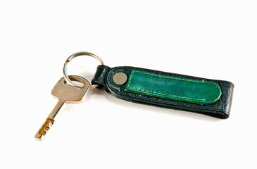 old key attached to a leather keychain