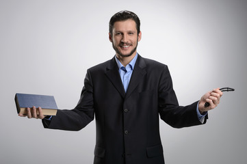 Religious businessman. Cheerful bearded man in formalwear holdin