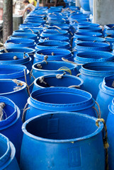water in blue plastic 200 litre open top barrel