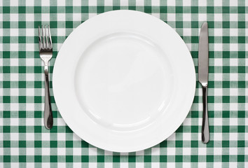 table setting on green Gingham tablecoth