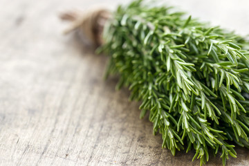 Rosemary on rustic wooden table background