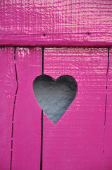 Fuchsine painted wooden window shutter with cut out Heart shape