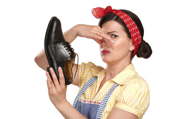 beautiful vintage housekeeper holding  a smelly shoes with facia
