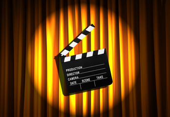 Movie clapper board against curtain