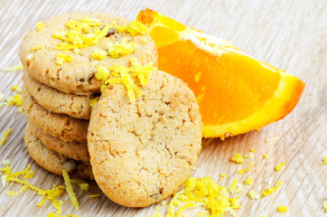 cookies and orange fruit on wood background