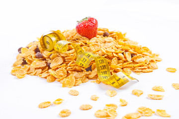 muesli and flakes with fruites and measuring tape