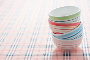 stack of colorful bowls on fabric background