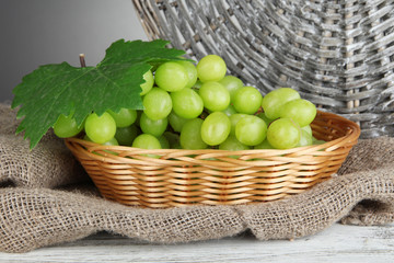Ripe delicious grapes in wicker basket