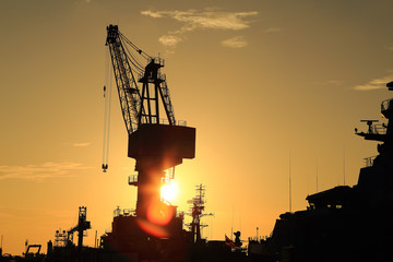 Cranes in dockyard  at sunset