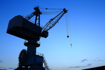 Cranes in dockyard  at sunset