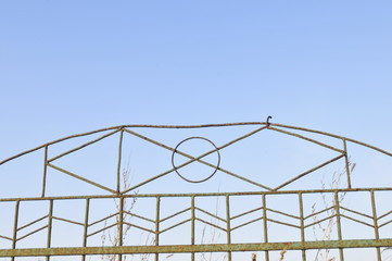 Fototapeta premium Wrought iron door decoration in the blue sky