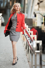 Young businesswoman walking on the city street