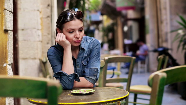 Sad, depressed pretty woman sitting in cafe