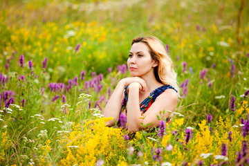 Naklejka na ściany i meble Beautiful Young Woman in outdoors, enjoying nature and smiling