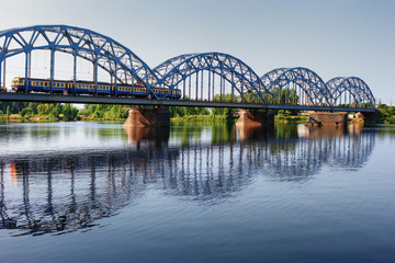 Passenger train on the bridge across the river