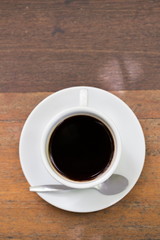 close up a cup of coffee on wooden table