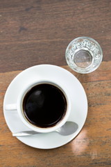 close up a cup of coffee on wooden table