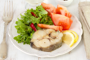 boiled fish with salad and lemon