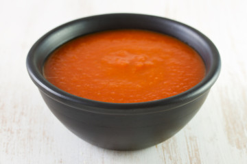 tomato soup in black dish