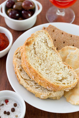 bread on the white plate and olives
