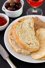 bread on the plate with olives and sauce