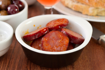 fried chourico with bread and olives