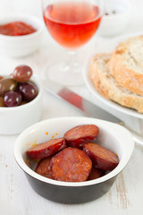 fried sausages with bread and olives
