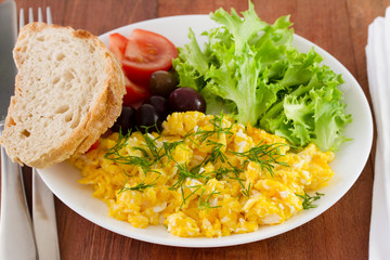 egg with salad and bread on the plate