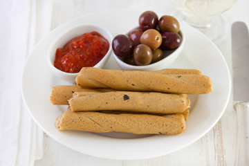 bread stick with sauce and olives