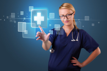 Young nurse pressing modern medical type of buttons