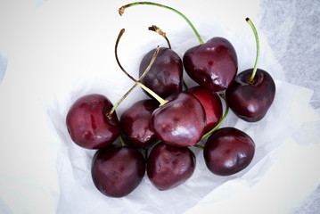 Cherries on white paper background