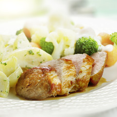 Grilled ham served  with cauliflower broccoli carrot and potatoe